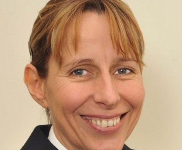 Headshot portrait of Jane Sawyers in uniform smiling